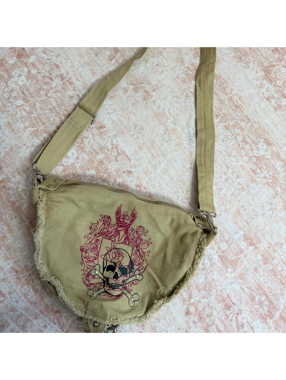 Khaki y2k shoulder bag with edgy skull + crossbones graphic